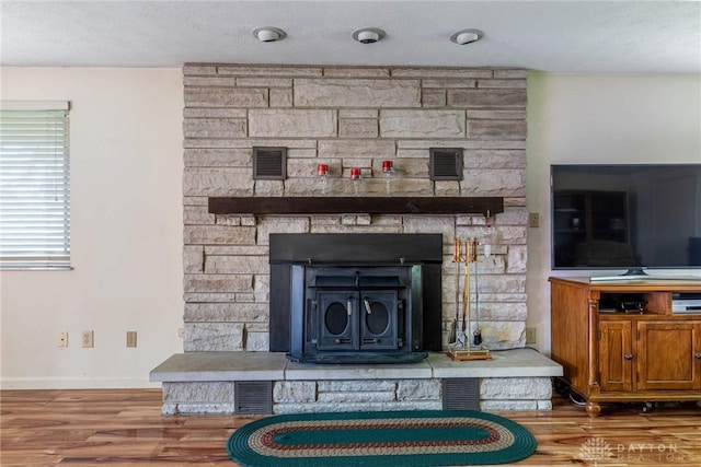 9131 Shawhan Dr, Centerville, OH 45458 - detailed view of a stone fireplace, wood finished floors, and a textured ceiling