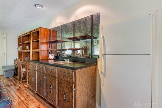 9131 Shawhan Dr, Centerville, OH 45458 - kitchen with freestanding refrigerator, open shelves, dark countertops, light wood-style floors, and a textured ceiling