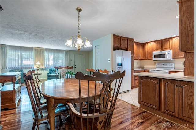 9131 Shawhan Dr, Centerville, OH 45458 - dining space featuring a chandelier, light wood finished floors, and recessed lighting