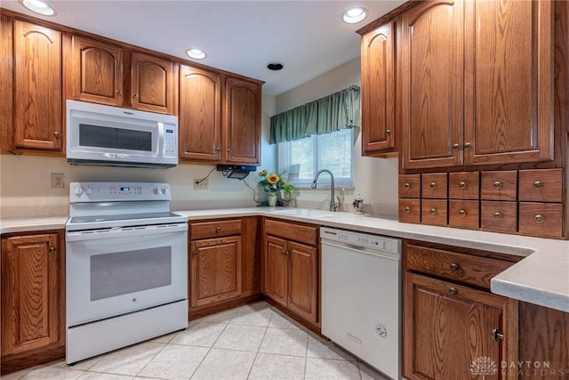 9131 Shawhan Dr, Centerville, OH 45458 - kitchen with white appliances, light tile patterned floors, brown cabinetry, light countertops, and recessed lighting