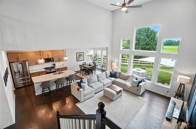 4835 Granada Ct, Liberty Twp, OH 45044 - living area with a towering ceiling, ceiling fan, and dark wood-style flooring
