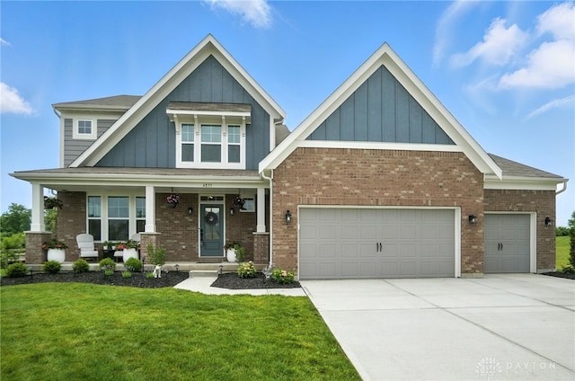 4835 Granada Ct, Liberty Twp, OH 45044 - craftsman-style house with board and batten siding, a front lawn, an attached garage, driveway, and a porch
