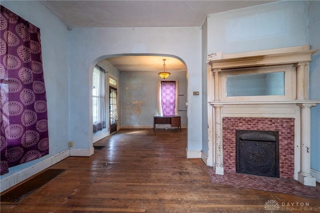246 N D St, Hamilton, OH 45013 - unfurnished living room with arched walkways, wood-type flooring, and a fireplace