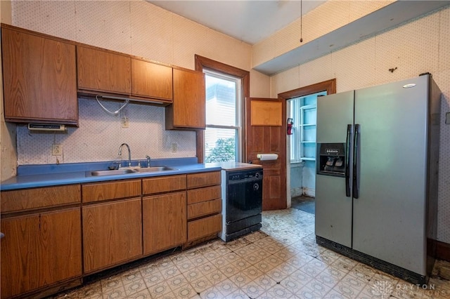 246 N D St, Hamilton, OH 45013 - kitchen with stainless steel fridge, black dishwasher, light flooring, brown cabinets, and wallpapered walls