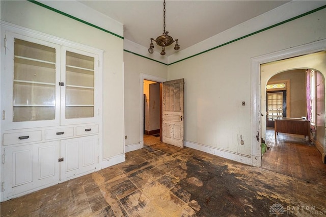 246 N D St, Hamilton, OH 45013 - unfurnished dining area with arched walkways and baseboards