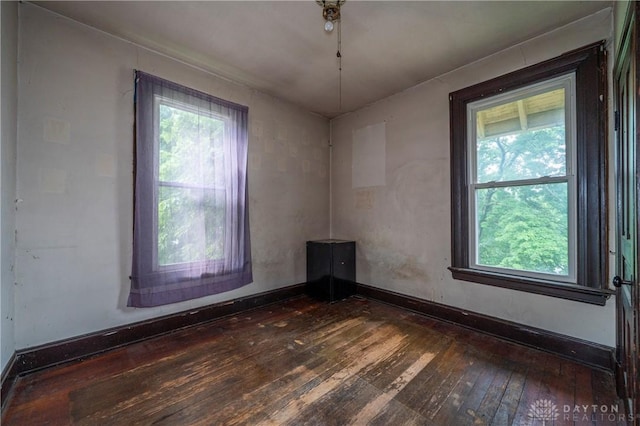 246 N D St, Hamilton, OH 45013 - spare room featuring dark wood finished floors and healthy amount of natural light
