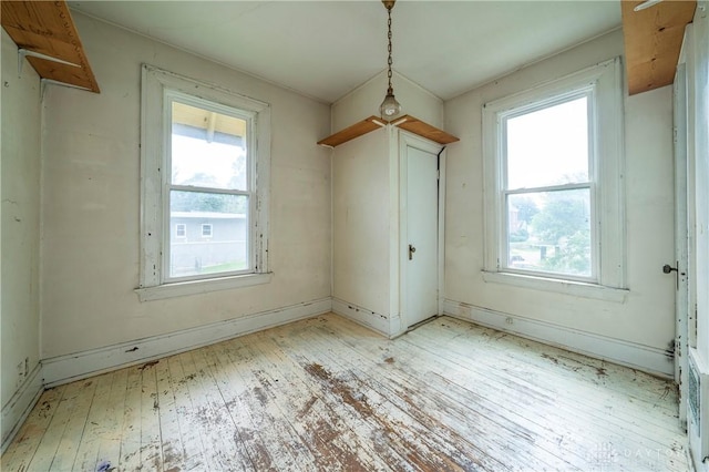 246 N D St, Hamilton, OH 45013 - unfurnished dining area featuring wood-type flooring and baseboards