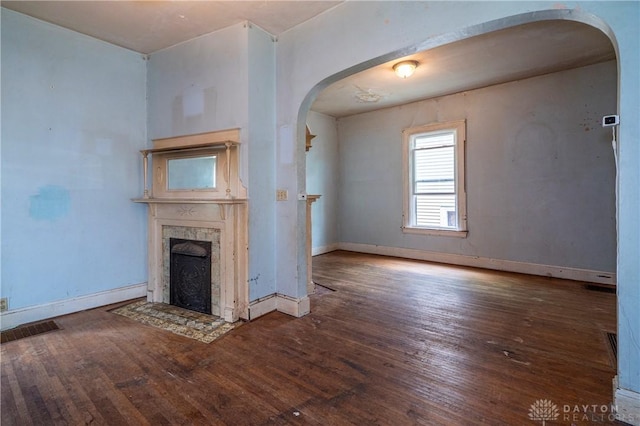 246 N D St, Hamilton, OH 45013 - unfurnished living room with arched walkways, wood-type flooring, and a premium fireplace