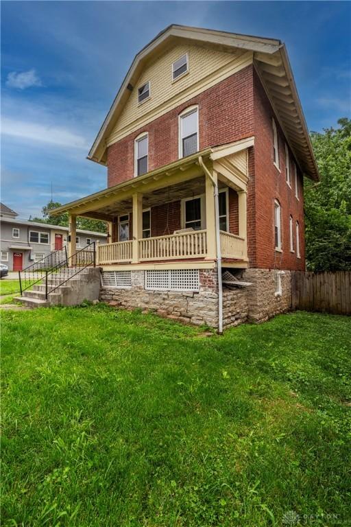 246 N D St, Hamilton, OH 45013 - view of front of house with brick siding and covered porch