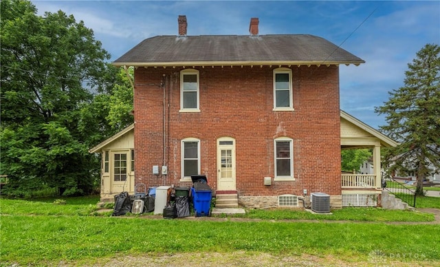 246 N D St, Hamilton, OH 45013 - back of house featuring a yard, a chimney, brick siding, entry steps, and a porch