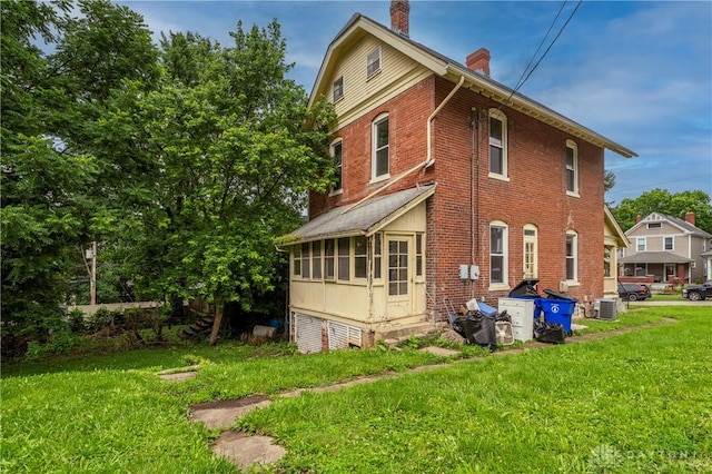 246 N D St, Hamilton, OH 45013 - rear view of property featuring a chimney, a yard, and brick siding