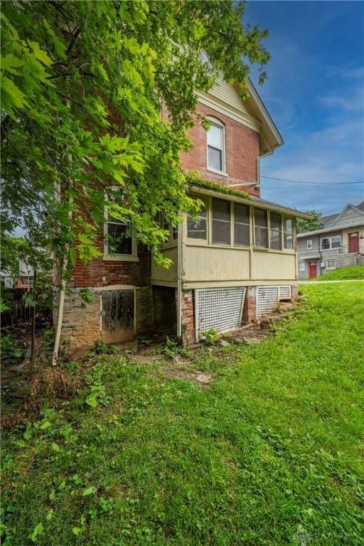 246 N D St, Hamilton, OH 45013 - rear view of property featuring a sunroom and a yard