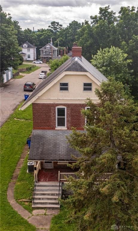 246 N D St, Hamilton, OH 45013 - back of house featuring a chimney and brick siding