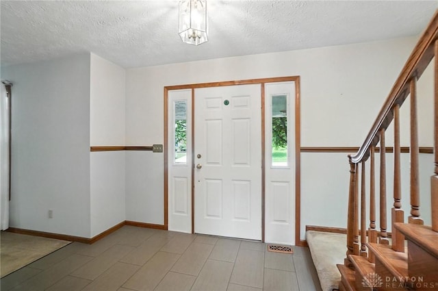356 Saint James Pl, Springboro, OH 45066 - entryway with stairway and a textured ceiling