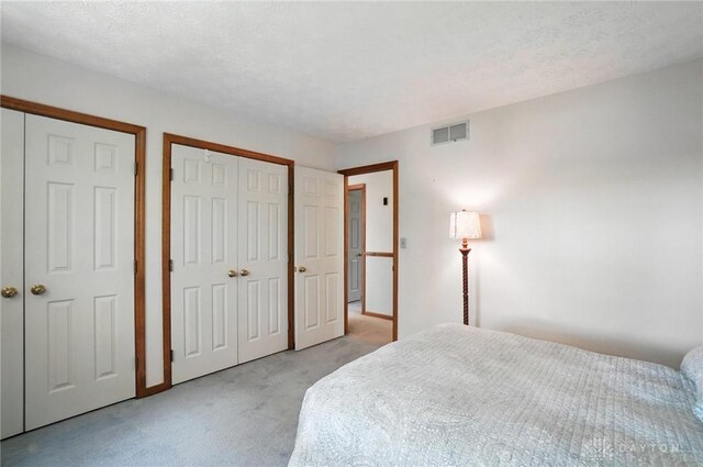 356 Saint James Pl, Springboro, OH 45066 - bedroom featuring light colored carpet and two closets