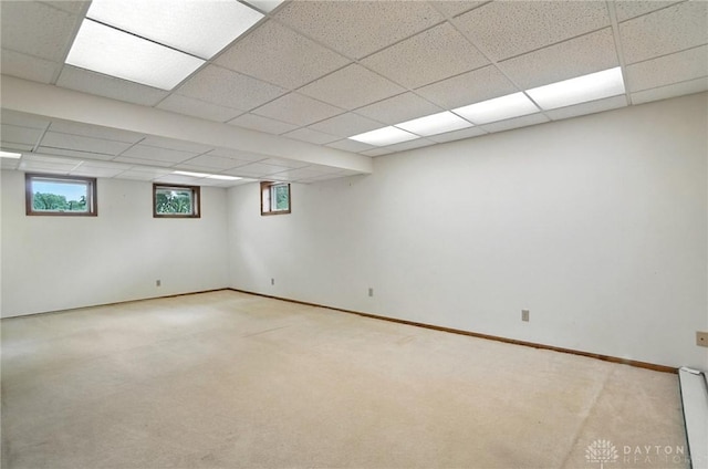 356 Saint James Pl, Springboro, OH 45066 - basement featuring a paneled ceiling, light colored carpet, and baseboard heating