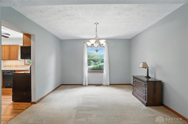 356 Saint James Pl, Springboro, OH 45066 - unfurnished dining area featuring a chandelier, light colored carpet, and a textured ceiling