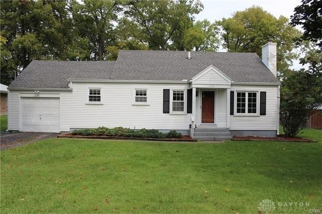 508 Shiloh Dr, Harrison Twp, OH 45415 - view of front of home featuring an attached garage, a chimney, driveway, a front lawn, and roof with shingles