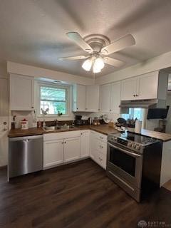 1006 Terracewood Dr, Englewood, OH 45322 - kitchen featuring appliances with stainless steel finishes, under cabinet range hood, white cabinets, dark wood finished floors, and ceiling fan