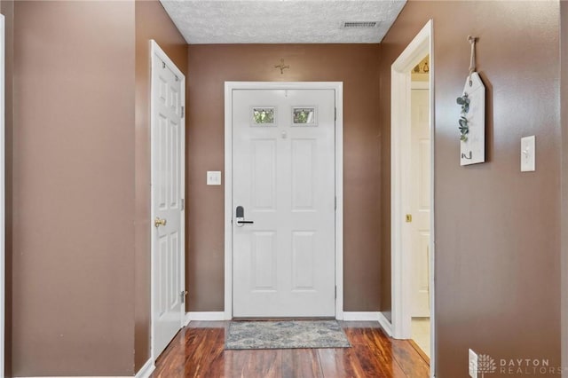 5545 Stone Path Dr, Middletown, OH 45042 - foyer entrance featuring dark wood-style floors and a textured ceiling
