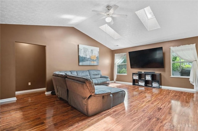 5545 Stone Path Dr, Middletown, OH 45042 - living room featuring a skylight, ceiling fan, wood finished floors, lofted ceiling, and healthy amount of natural light