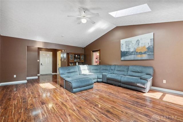 5545 Stone Path Dr, Middletown, OH 45042 - living area with wood finished floors, a ceiling fan, vaulted ceiling, and a skylight