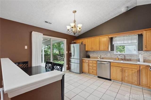 5545 Stone Path Dr, Middletown, OH 45042 - kitchen featuring appliances with stainless steel finishes, vaulted ceiling, a chandelier, decorative backsplash, and a textured ceiling