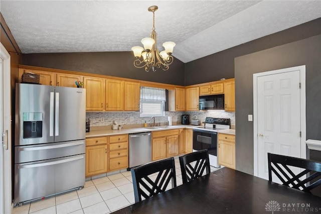 5545 Stone Path Dr, Middletown, OH 45042 - kitchen with stainless steel appliances, a chandelier, vaulted ceiling, backsplash, and a textured ceiling