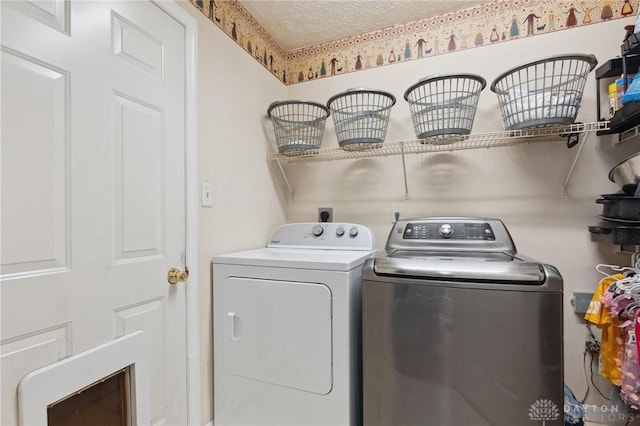 5545 Stone Path Dr, Middletown, OH 45042 - laundry room featuring washer and clothes dryer and a textured ceiling