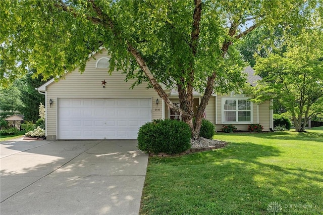 5545 Stone Path Dr, Middletown, OH 45042 - view of property hidden behind natural elements with concrete driveway, a front yard, and a garage