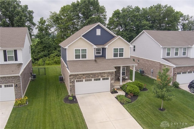 2225 Cold Stream Dr, Clearcreek Twp, OH 45458 - view of front of property with a garage, concrete driveway, a front lawn, and stone siding