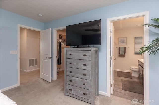 2225 Cold Stream Dr, Clearcreek Twp, OH 45458 - bedroom featuring a spacious closet, light colored carpet, ensuite bathroom, and a closet