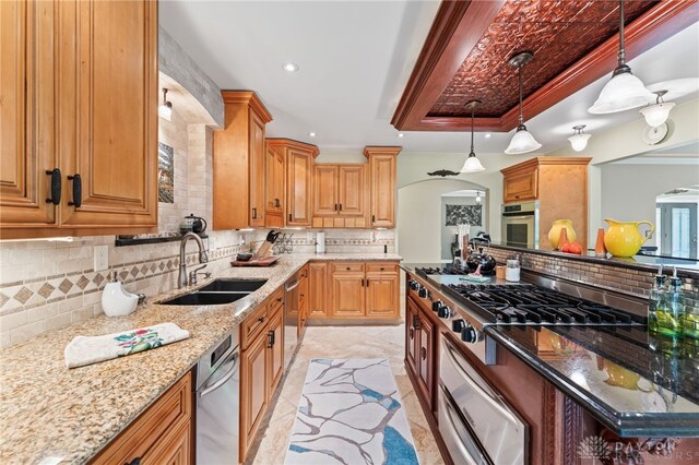 255 Belle Watlin Ct, Dayton, OH 45434 - kitchen with stainless steel appliances, tasteful backsplash, a tray ceiling, a warming drawer, and arched walkways