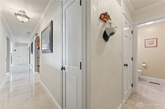 255 Belle Watlin Ct, Dayton, OH 45434 - hallway with arched walkways, crown molding, a textured wall, and light marble finish flooring