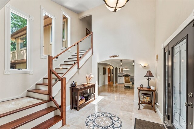 255 Belle Watlin Ct, Dayton, OH 45434 - foyer entrance with arched walkways, stairs, and a high ceiling