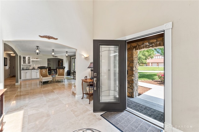 255 Belle Watlin Ct, Dayton, OH 45434 - entrance foyer with arched walkways, a towering ceiling, and light tile patterned floors