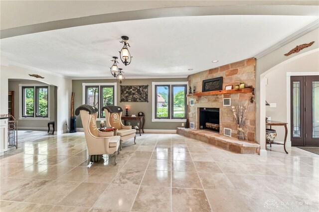 255 Belle Watlin Ct, Dayton, OH 45434 - living room with crown molding, arched walkways, and a stone fireplace