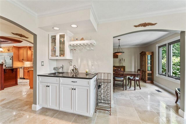 255 Belle Watlin Ct, Dayton, OH 45434 - indoor wet bar with arched walkways, appliances with stainless steel finishes, crown molding, hanging light fixtures, and recessed lighting