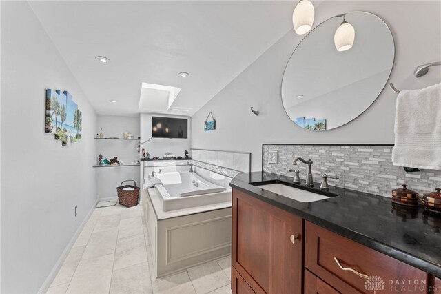 255 Belle Watlin Ct, Dayton, OH 45434 - kitchen with a skylight, backsplash, light tile patterned floors, dark countertops, and recessed lighting