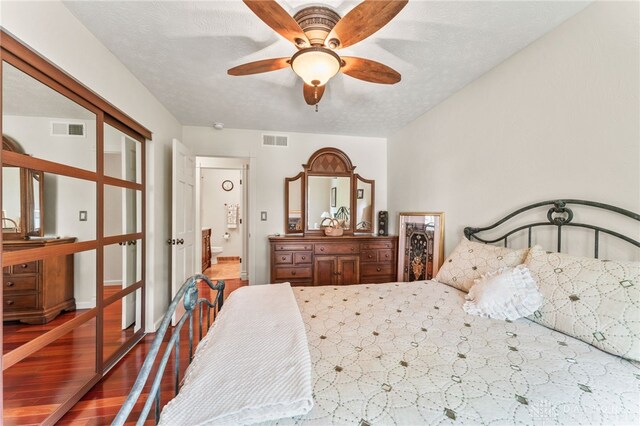 255 Belle Watlin Ct, Dayton, OH 45434 - bedroom with wood finished floors, ensuite bath, and ceiling fan