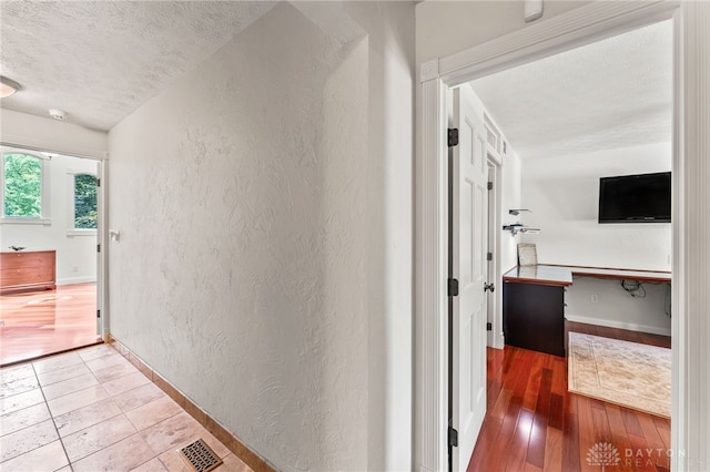 255 Belle Watlin Ct, Dayton, OH 45434 - hallway featuring a textured wall, a textured ceiling, and wood finished floors