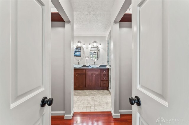 255 Belle Watlin Ct, Dayton, OH 45434 - bathroom with wood finished floors, double vanity, and a textured ceiling