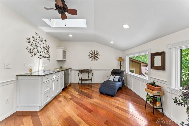 255 Belle Watlin Ct, Dayton, OH 45434 - sitting room with a skylight, ceiling fan, light wood-style floors, vaulted ceiling, and wainscoting