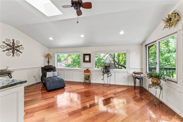 255 Belle Watlin Ct, Dayton, OH 45434 - living area featuring vaulted ceiling, a skylight, light wood-style flooring, a decorative wall, and a ceiling fan