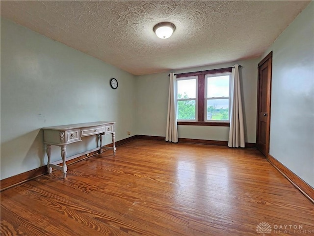 3054 Carpenter Rd, Jefferson Twp, OH 45335 - unfurnished room featuring wood finished floors and a textured ceiling