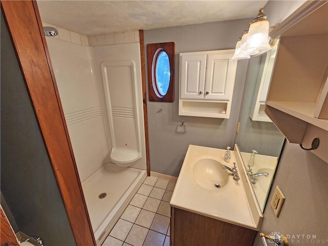 3054 Carpenter Rd, Jefferson Twp, OH 45335 - bathroom with a shower stall, vanity, tile patterned flooring, and a textured ceiling
