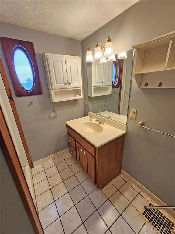 3054 Carpenter Rd, Jefferson Twp, OH 45335 - bathroom with tile patterned floors, vanity, and a textured ceiling