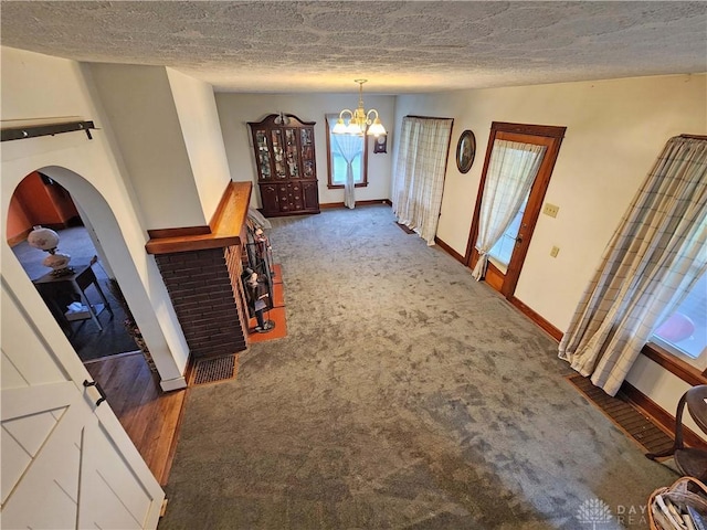 3054 Carpenter Rd, Jefferson Twp, OH 45335 - hallway featuring a chandelier, a textured ceiling, and carpet