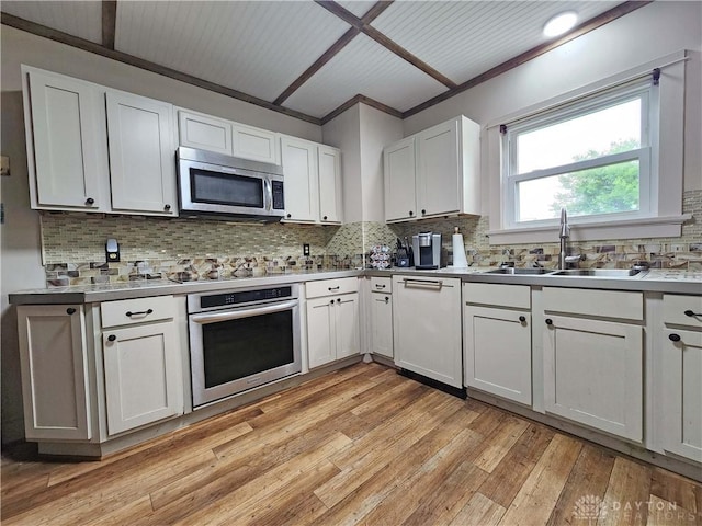 3054 Carpenter Rd, Jefferson Twp, OH 45335 - kitchen with appliances with stainless steel finishes, tasteful backsplash, light wood-type flooring, white cabinetry, and light countertops