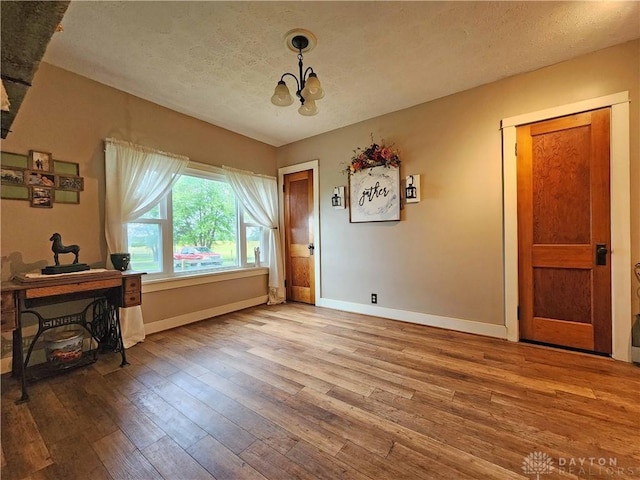 3054 Carpenter Rd, Jefferson Twp, OH 45335 - office space featuring a chandelier, wood-type flooring, and a textured ceiling